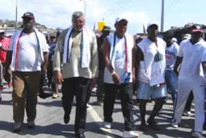 Former President Rawlings strolls with some party officials in Accra